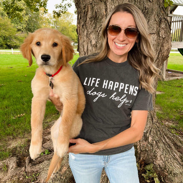 Unisex Comfort Wash Graphic Tee with "LIFE HAPPENS DOGS HELP" print in pepper color.