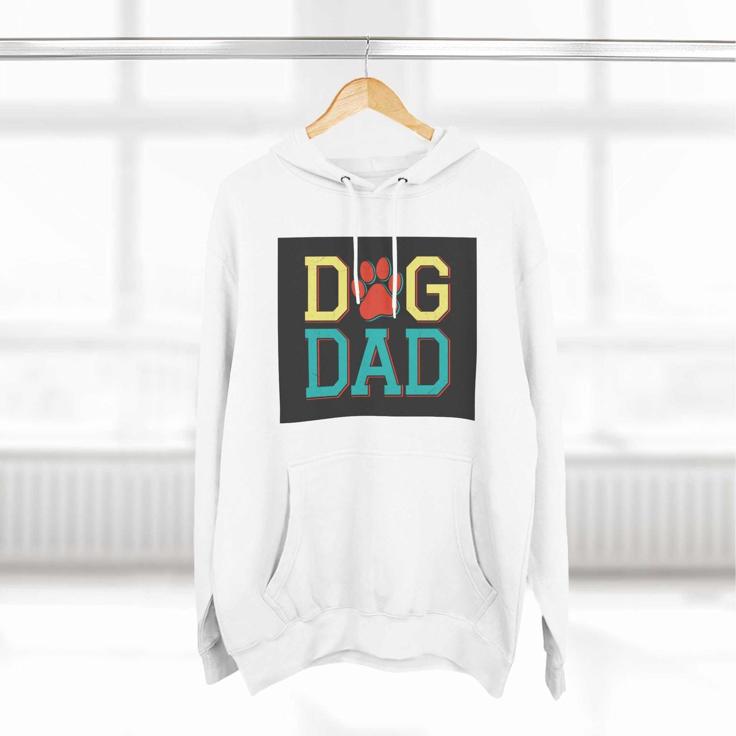 Three-panel fleece hoodie with "Dog Dad" design on a hanger, featuring premium fabric and cozy fit.