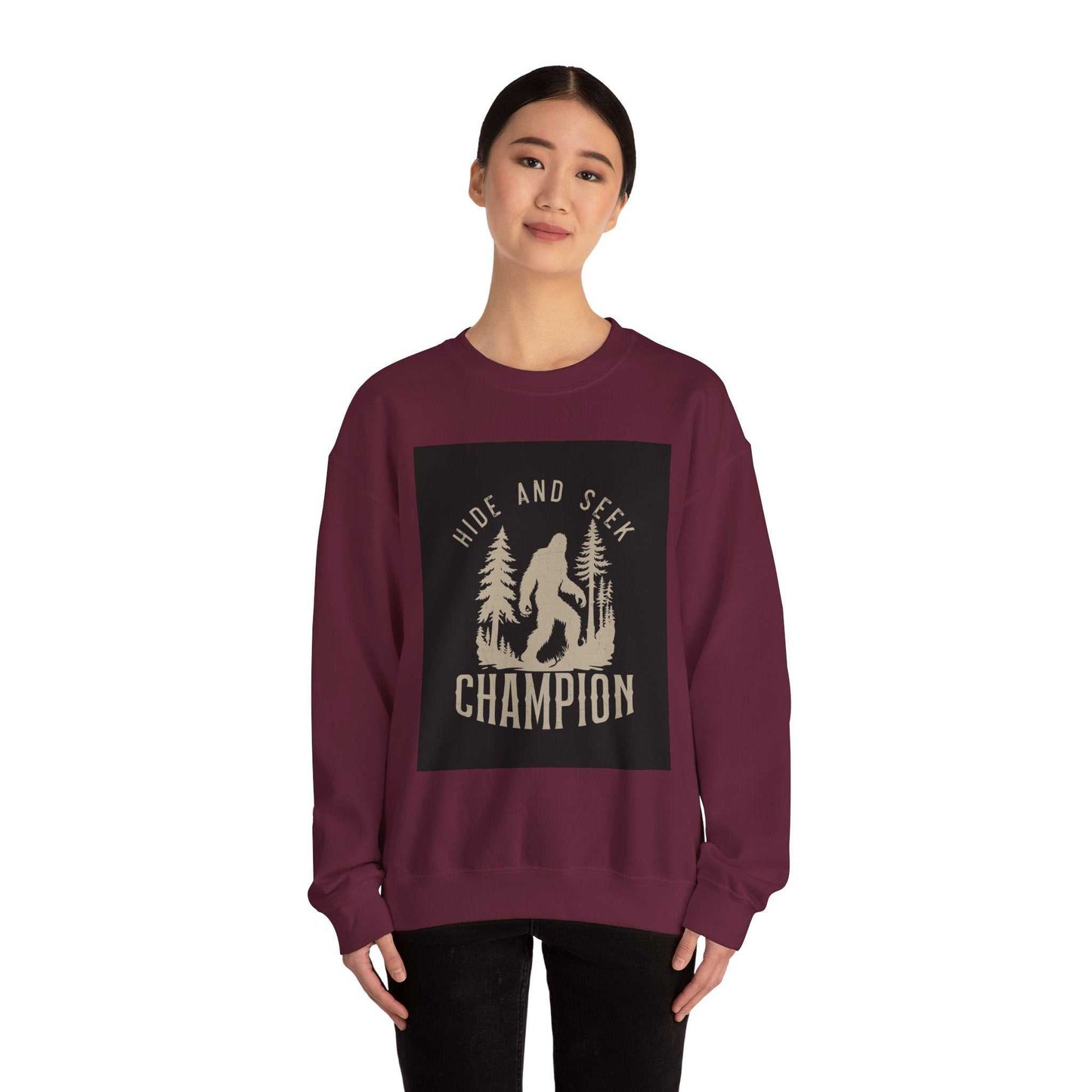 Unisex Heavy Blend™ Crewneck Sweatshirt in maroon with hide and seek champion graphic, ribbed collar, double-needle stitching for durability.