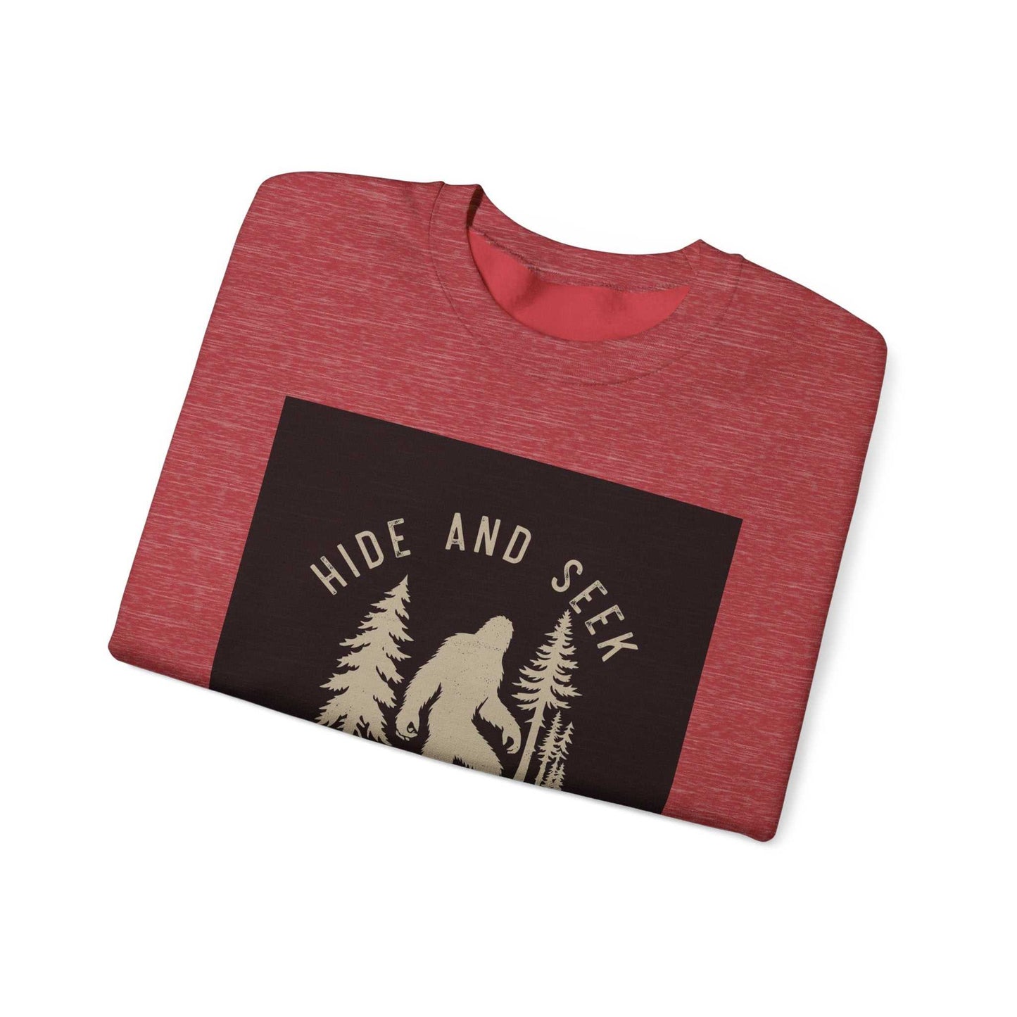 Unisex Heavy Blend™ Crewneck Sweatshirt in red, featuring a "Hide and Seek" graphic with a silhouette of a figure among trees; cozy cotton-polyester blend, ideal for colder months.