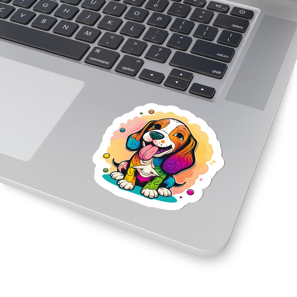 Kiss-cut sticker on laptop showing colorful dog design with durable vinyl and glossy finish.