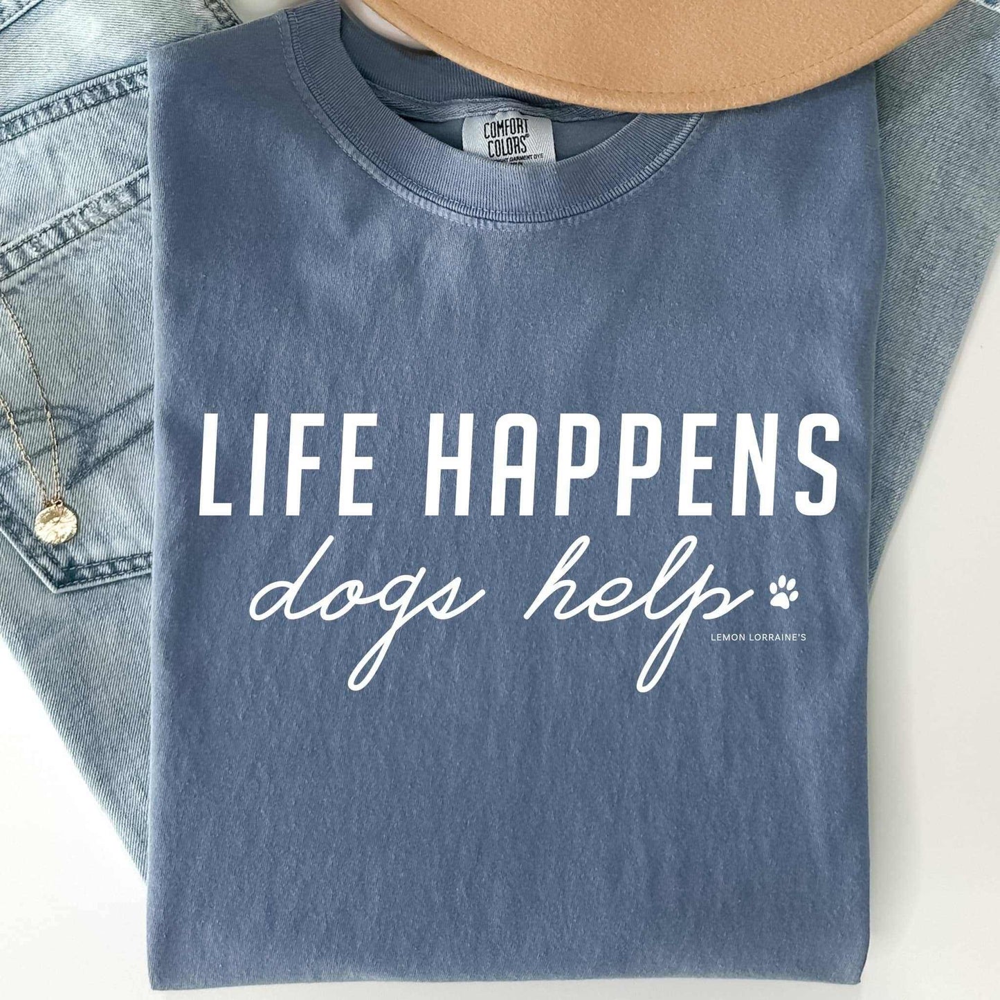 Comfort Wash Graphic Tee with "LIFE HAPPENS DOGS HELP" text on saltwater color, unisex fit.