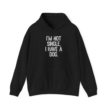 Unisex heavy cotton hoodie with kangaroo pocket and drawstring hood, featuring "I'm Not Single, I Have a Dog" print.