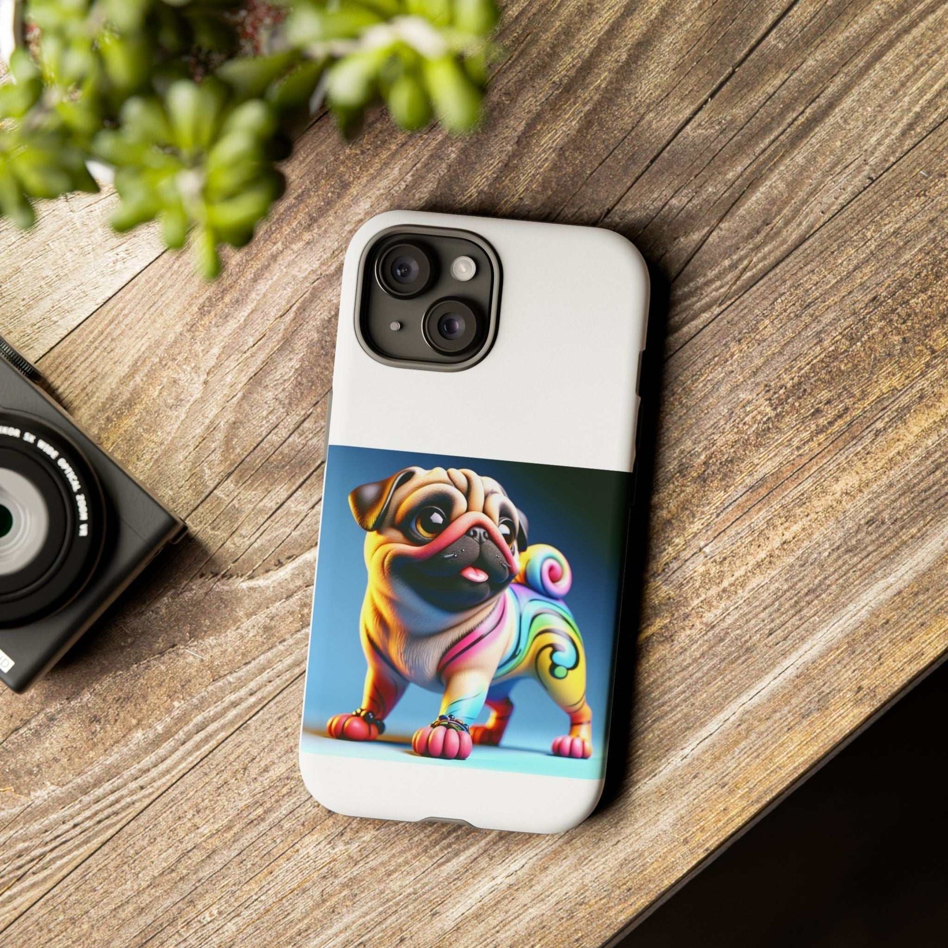 Pug dog phone case with 3D design on wooden surface.