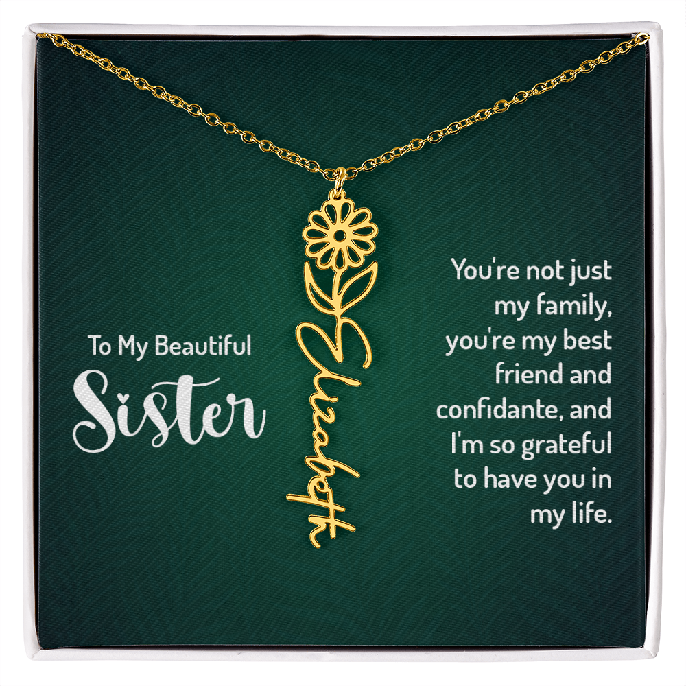 Personalized sister necklace with floral design and cursive name on a green background.