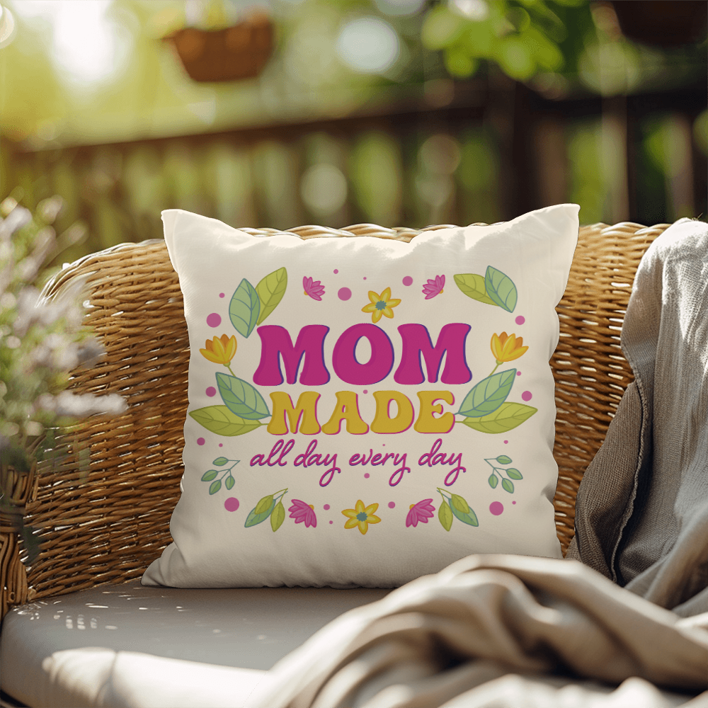 Cozy indoor-outdoor pillow with "Mom made all day every day" design on a wicker chair.