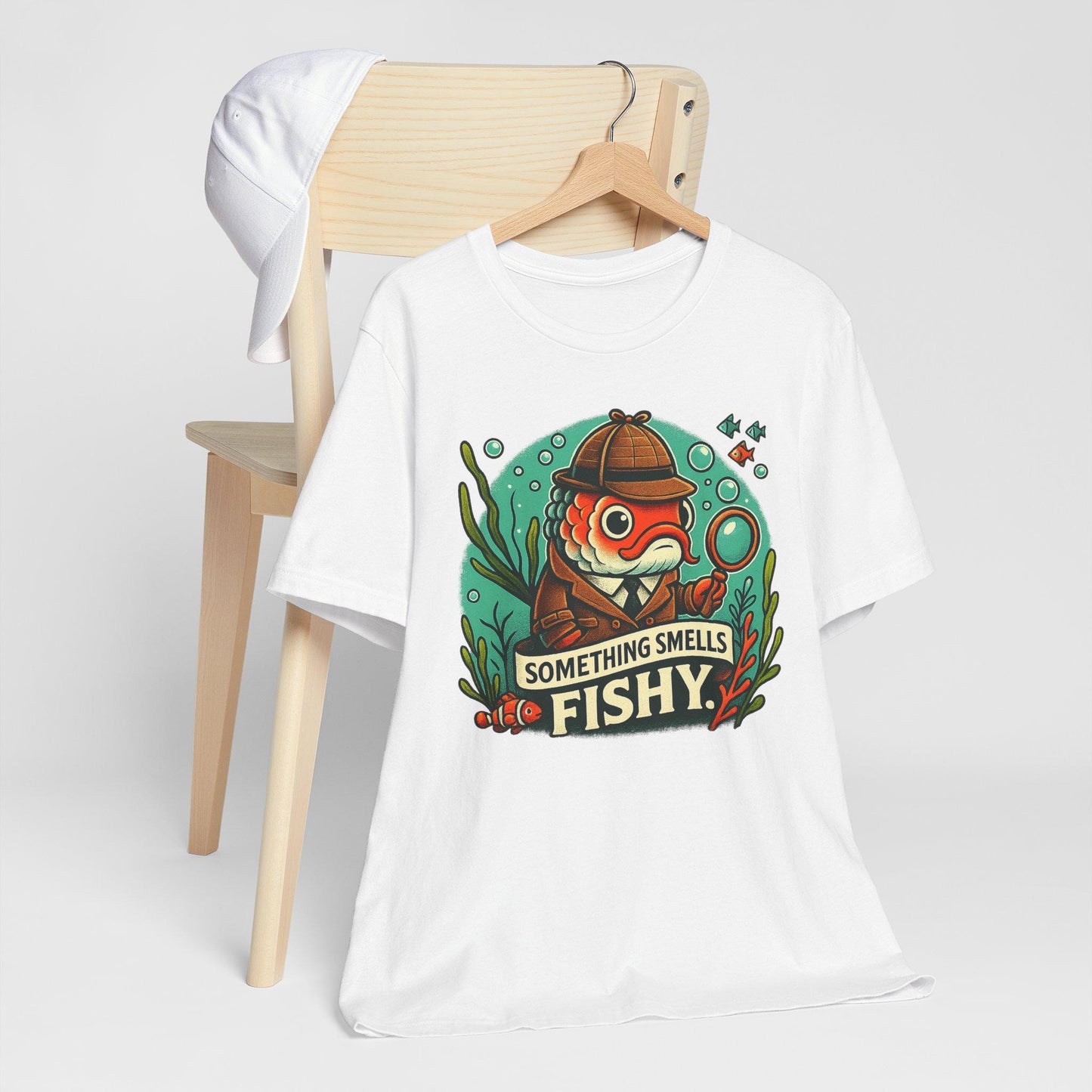 Something smells fishy Unisex Jersey Short Sleeve Tee Fish dressed up as a detective with a magnifying glass underwater fish swimming by. - Toddcraft