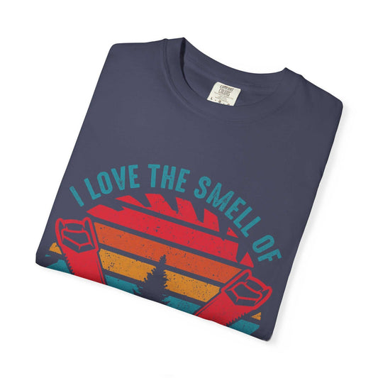 Unisex Garment-Dyed T-shirt folded, featuring "I Love The Smell Of" design on soft-washed, garment-dyed fabric.