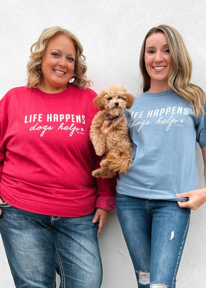 Comfort Wash Graphic Tee in saltwater color with "LIFE HAPPENS DOGS HELP" print, worn by two people and a dog.