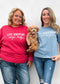 Comfort Wash Graphic Tee in saltwater color with "LIFE HAPPENS DOGS HELP" print, worn by two people and a dog.