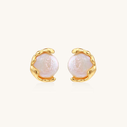 Gold-plated sterling silver stud earrings with organic claw settings cradling lustrous freshwater pearls on white background.