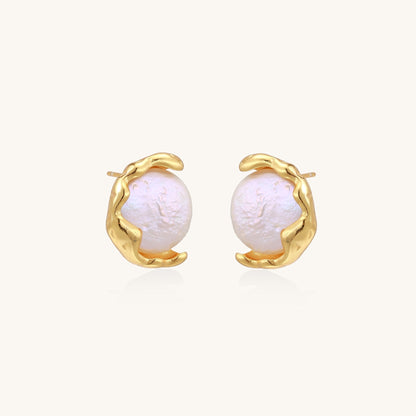 Gold-plated sterling silver stud earrings with organic claw settings cradling lustrous freshwater pearls on white background.
