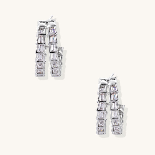 Gold-plated huggie hoops featuring vertical rows of clear baguette zirconia stones in geometric linear design