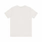 Unisex jersey short sleeve tee in soft cream color, featuring a classic fit, lightweight fabric, and crew neckline.