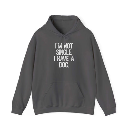 Unisex heavy cotton hoodie with front pocket and drawstring hood, reading "I'm not single, I have a dog".