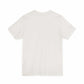 Unisex jersey short sleeve tee in beige, featuring a soft cotton blend with ribbed knit collar and tapered shoulders.