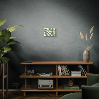 Matte canvas art displayed on a wall above a wooden shelf with books and decor.