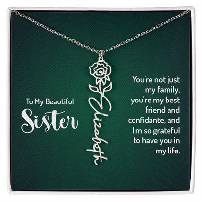 Personalized sister necklace with floral design and custom name engraving.