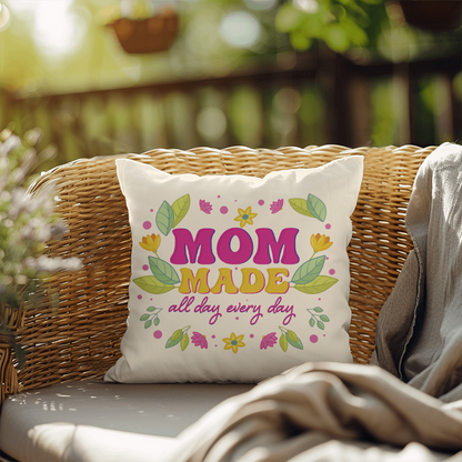 IndoorOutdoor Pillow with "Mom Made All Day Every Day" design on a wicker chair outdoors.