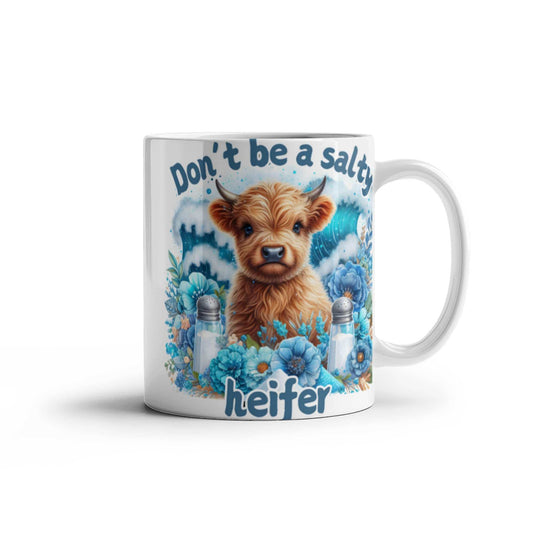 Humorous coffee mug with "Don't be a salty heifer" design, featuring a cute cow illustration.