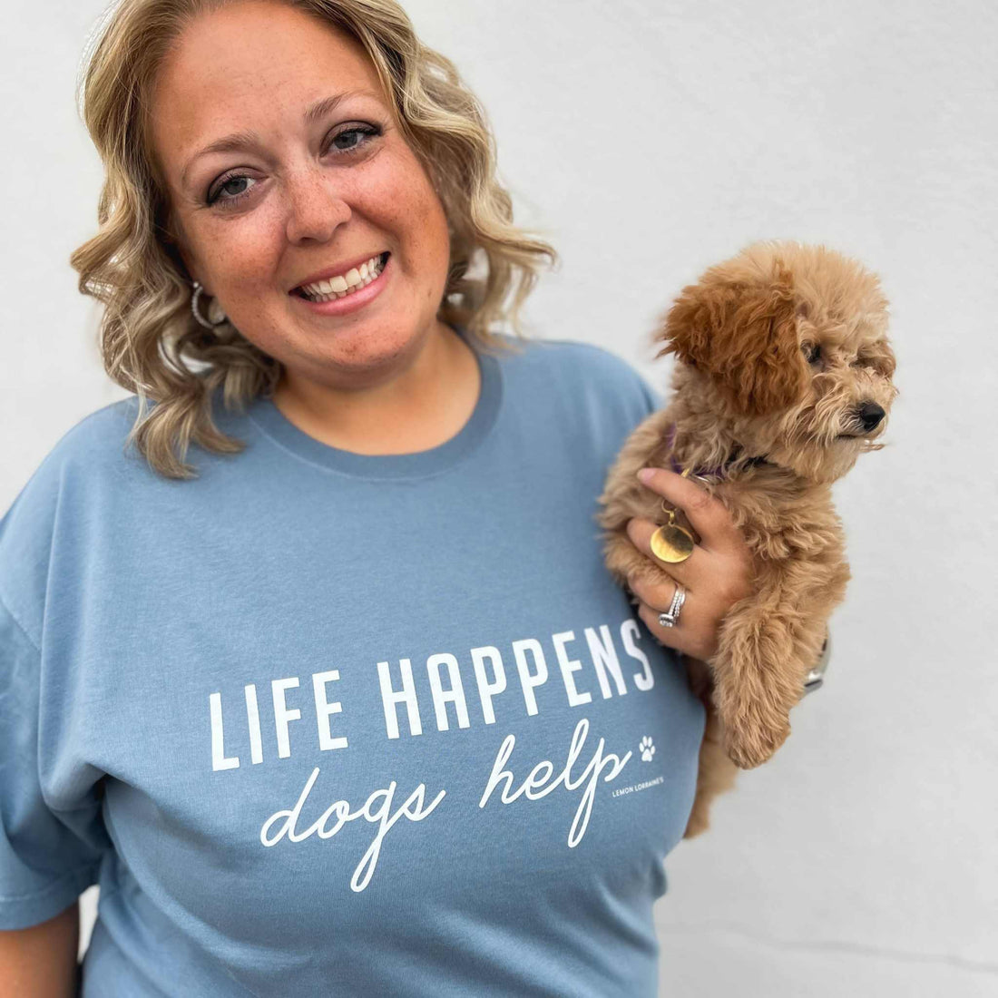Comfort Wash Graphic Tee in saltwater color with "Life Happens Dogs Help" text, unisex fit.