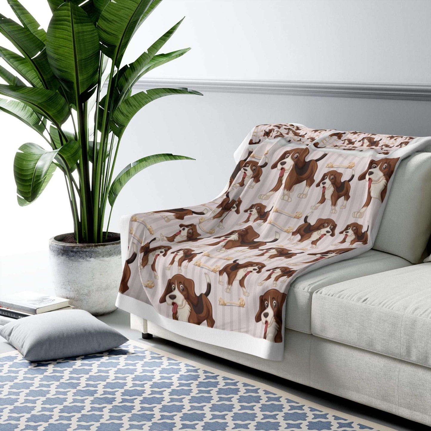 Sherpa fleece blanket with dog pattern draped over a couch, offering warmth and coziness.