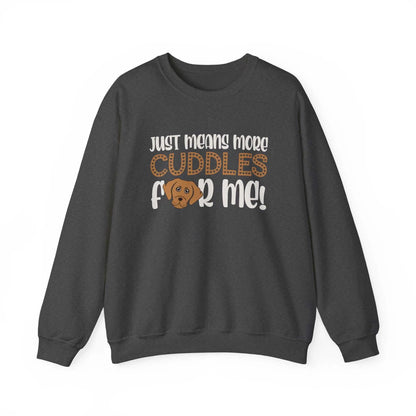Unisex heavy blend crewneck sweatshirt with "Just means more cuddles for me" slogan on dark fabric.
