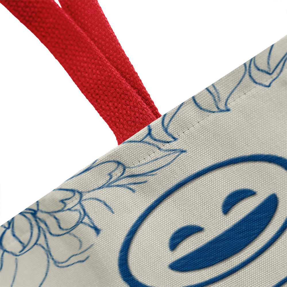 Classic Tote Bag with smiley design and red handles.